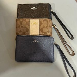 Three Coach wristlets